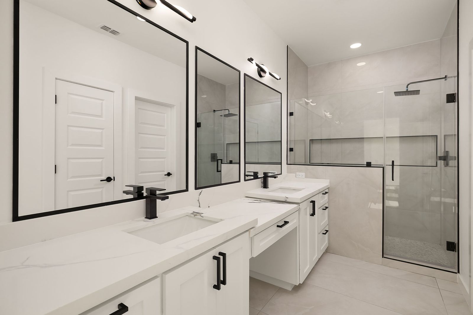 Bathroom with a double vanity and black fixtures — The Black Trim, a Kratos Construction custom home