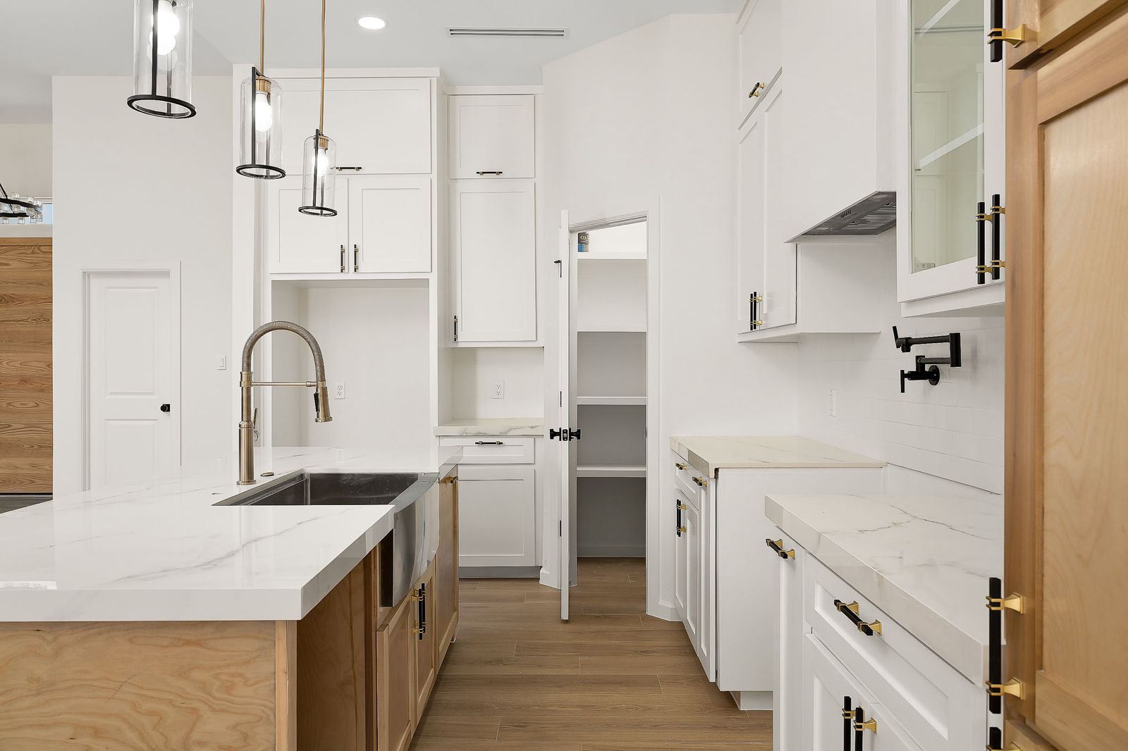 Kitchen and walk-in pantry with white and oak cabinetry — The Modern Farmhouse, a Kratos Construction custom home