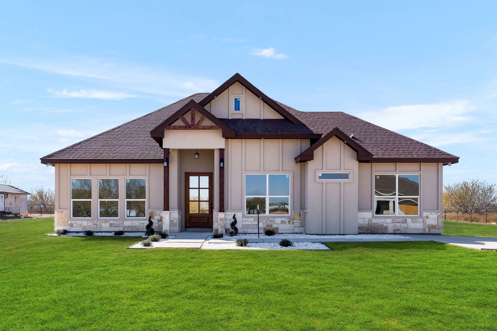Stone and stucco exterior with cedar gable trim — The Hill Country, a Kratos Construction custom home