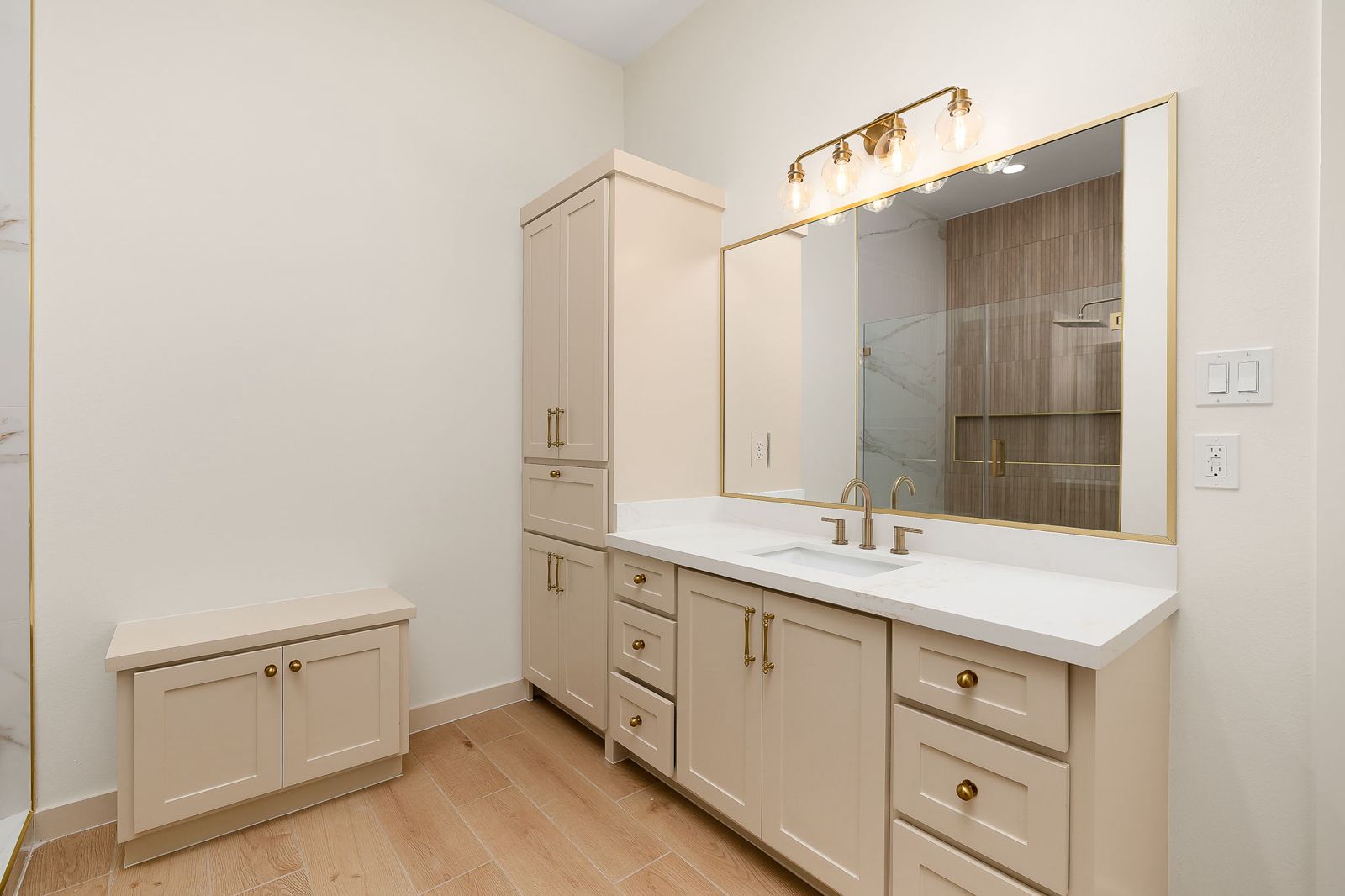 Bathroom vanity in cream cabinetry with gold hardware — The Hill Country, a Kratos Construction custom home
