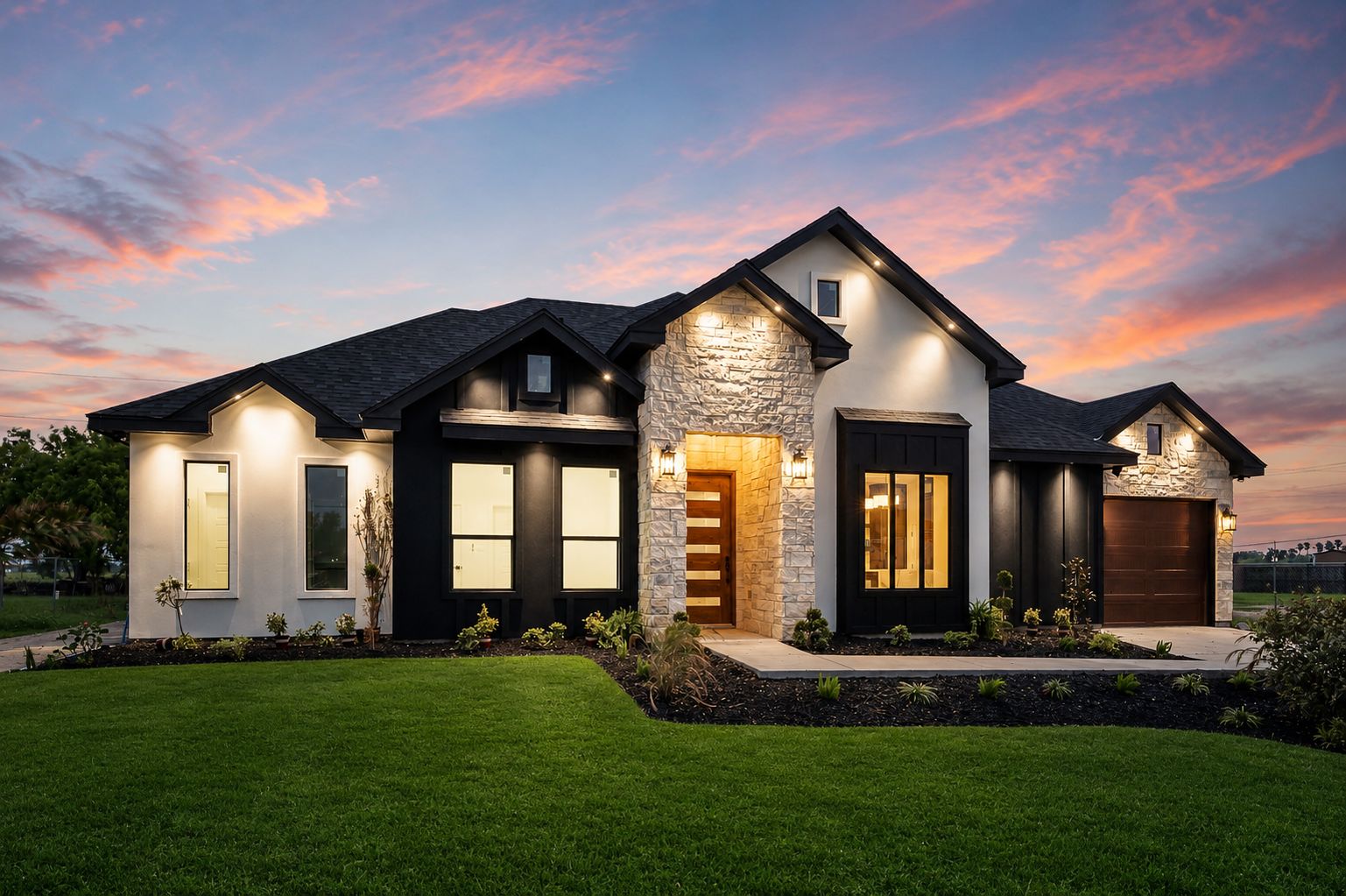 Dusk exterior with a stone-clad entry, black board-and-batten accents and a cedar front door — The Stone & Timber, a Kratos Construction custom home