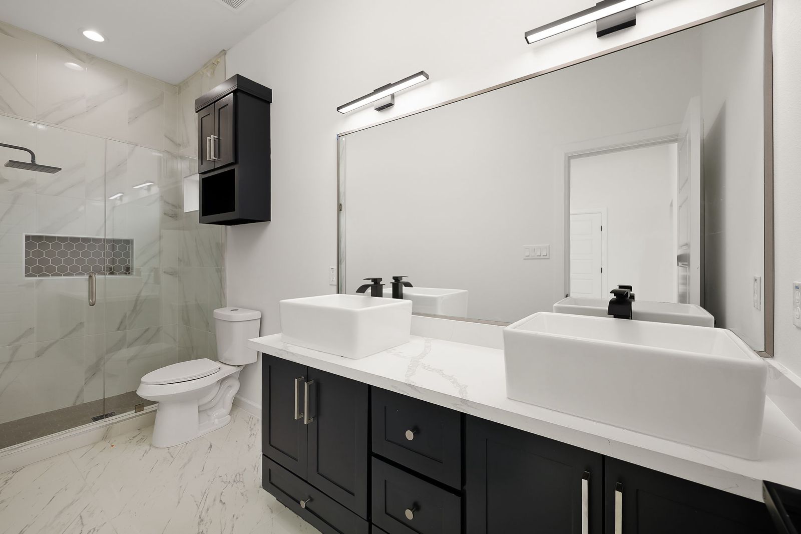 Bathroom with vessel sinks on a black vanity — The Stucco & Stone, a Kratos Construction custom home