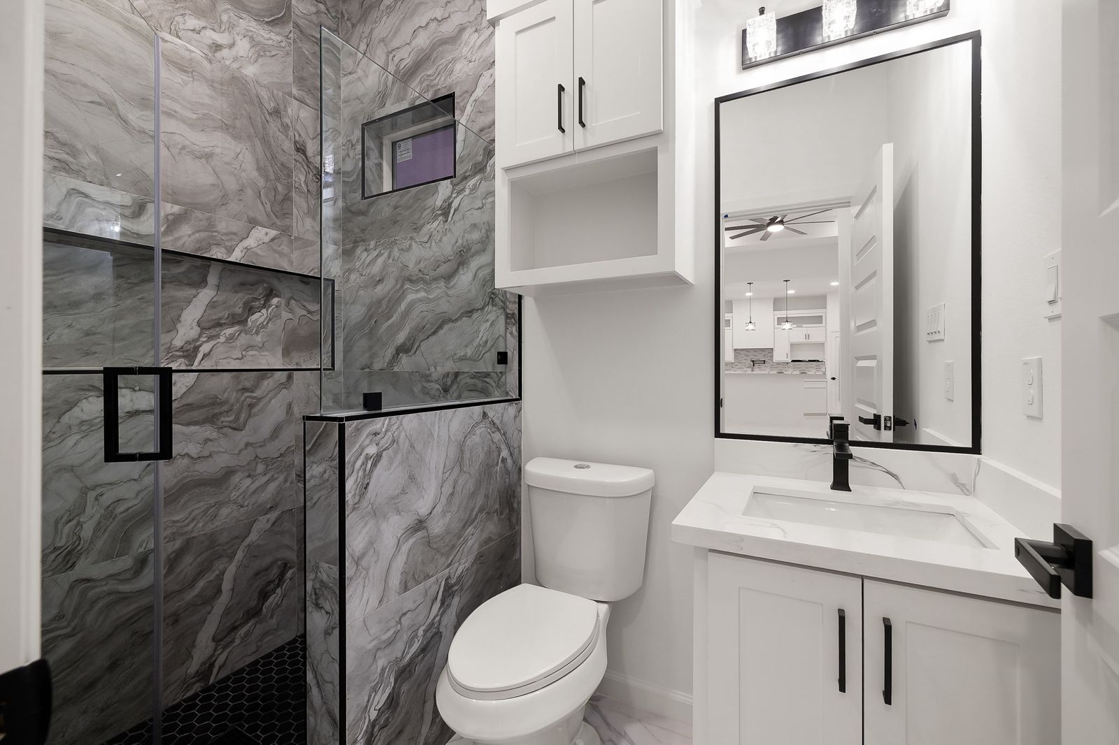 Bathroom with a glass shower and white shaker vanity — The Timber Gable, a Kratos Construction custom home