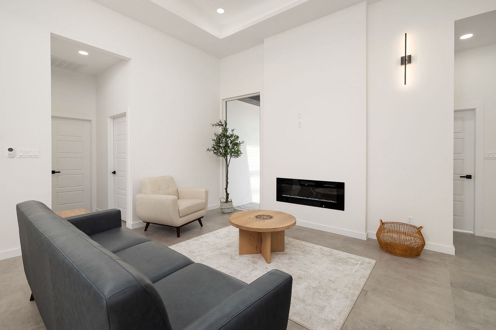 Staged living room with a linear fireplace — The White Brick, a Kratos Construction custom home